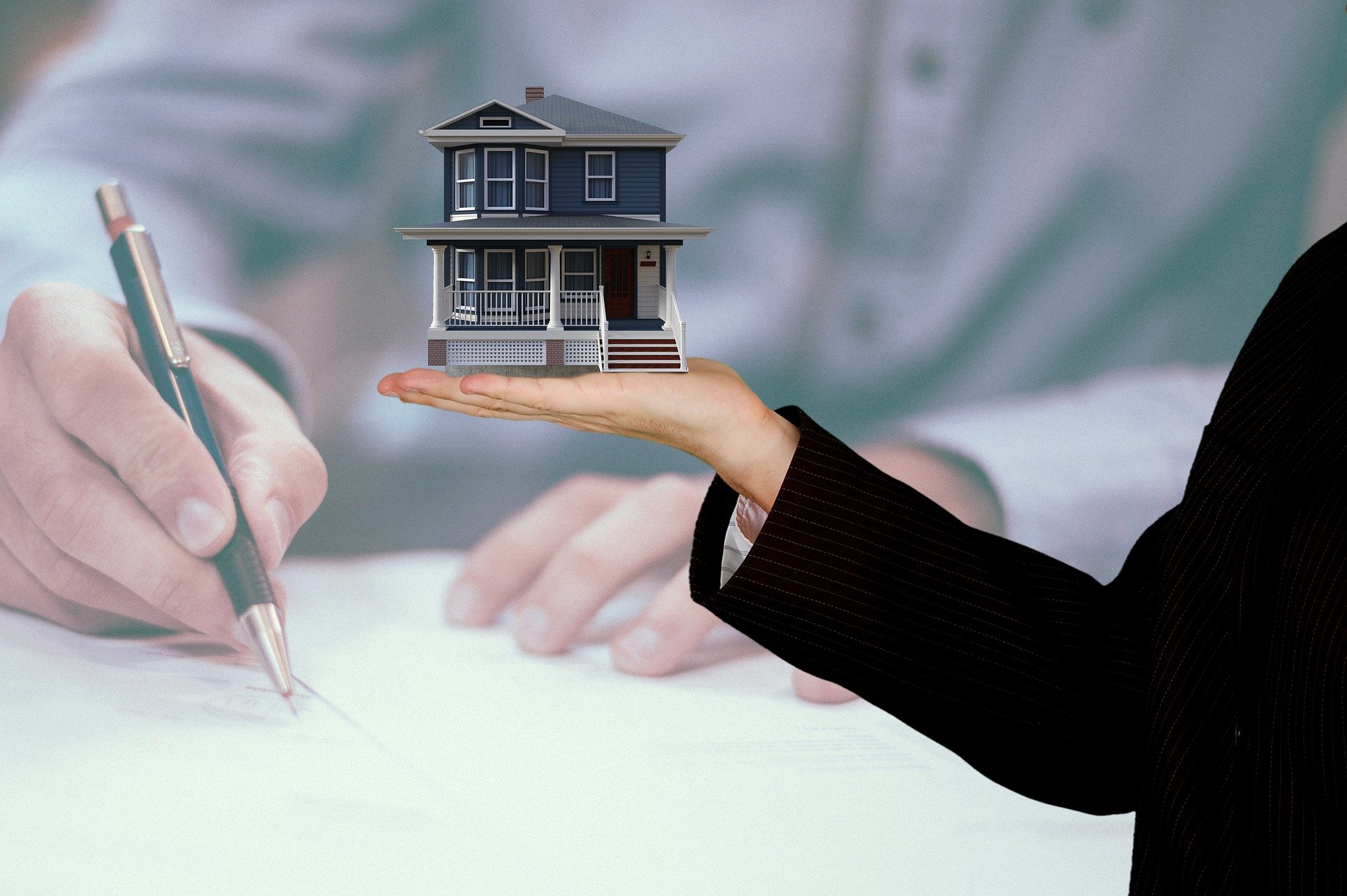 Man signing at a home closing